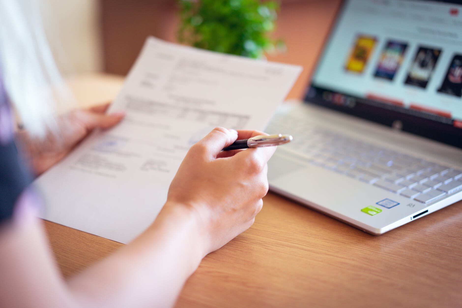 person holding pen and paper